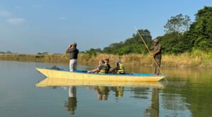 Our Travel Group canoeing on a river in Chitwan National Park surrounded by wildlife and nature